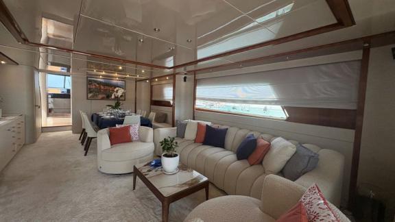 Among Athens yacht options interior salon of Mammas motor yacht with sofa seating area and dining table.
