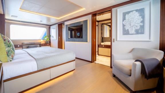 In Spain weekly yacht rental options Moka shows cabin with armchair and bathroom access.
