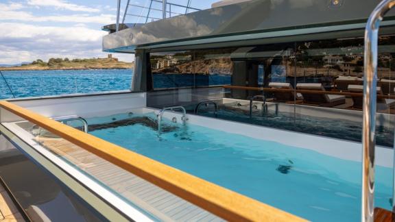 In Spain weekly yacht rental options Moka shows pool area and relaxing sea experience.