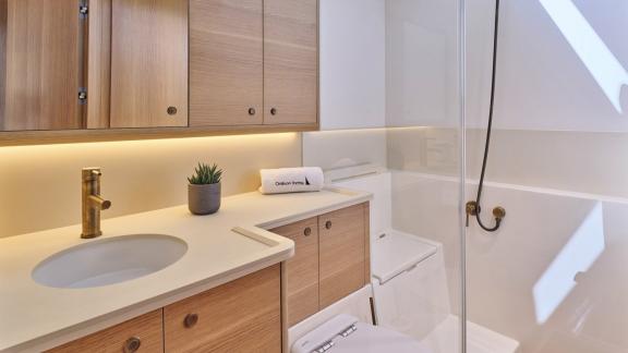 Off Lavrion the 3 cabin 6 guest Omikron Yachts OT 60 N ice featuring a modern bathroom with shower.