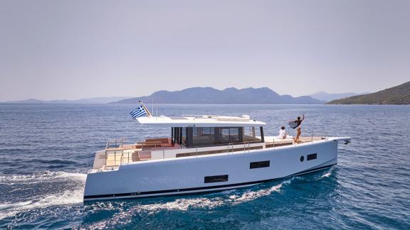 Off Lavrion the 3 cabin 6 guest Omikron Yachts OT 60 N ice motor yacht cruising at sea. Side profile view.