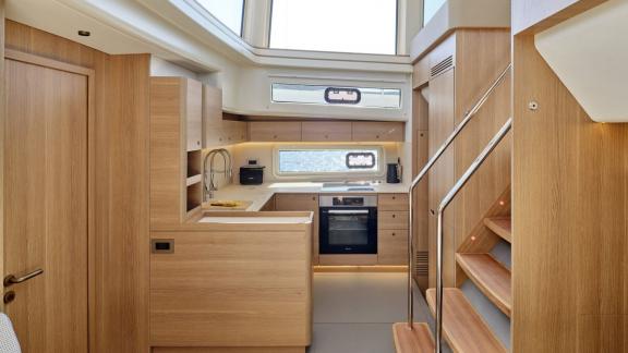 Off Lavrion the 3 cabin 6 guest Omikron Yachts OT 60 N ice featuring a modern galley with wooden interior.