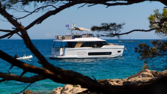 Framed by nature, motor yacht Olivia floats gracefully in the blue waters of the Adriatic.