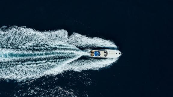 Among Cannes daily yacht rental options Omarta is seen from above cruising fast in open sea.