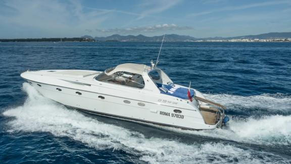 Among Cannes daily yacht rental options Omarta is seen from side cruising fast in open sea.