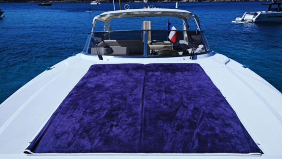 Among Cannes daily yacht rental options Omarta front deck shows large sunbathing cushions for relaxation.