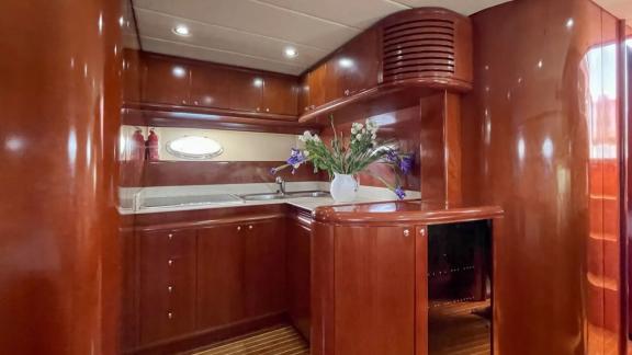 Among Cannes daily yacht rental options Omarta kitchen shows counter space and storage cabinets for use.