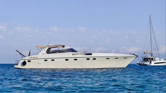 Among Cannes daily yacht rental options Omarta is seen anchored in calm sea with side profile view.