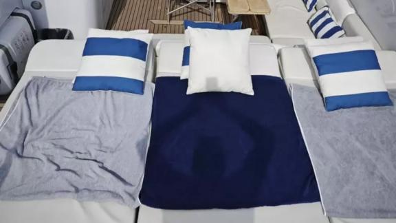 Among Cannes daily yacht rental options Omarta aft deck shows sunbathing cushions for relaxing onboard.