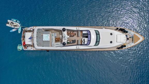 Seen from above near Athens, the yacht features a jacuzzi, dining area and water toys on deck.