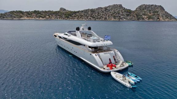Anchored off Athens, the Pareaki 2 yacht features paddle boards, a kayak and jet ski on the swim platform.