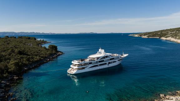 Premier motor yacht anchored in a secluded bay near Split, perfect for luxury yacht charters and private cruising holida