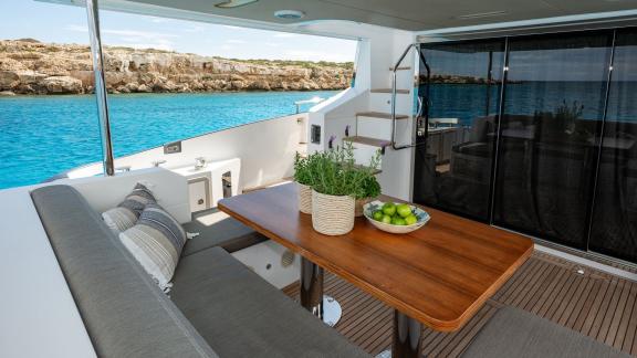 Sea Ya features an aft deck lounge and dining area, offering a comfortable yacht charter experience near Athens.