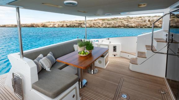 Sea Ya features an aft deck dining area, perfect for private yacht charter meals while cruising near Athens.