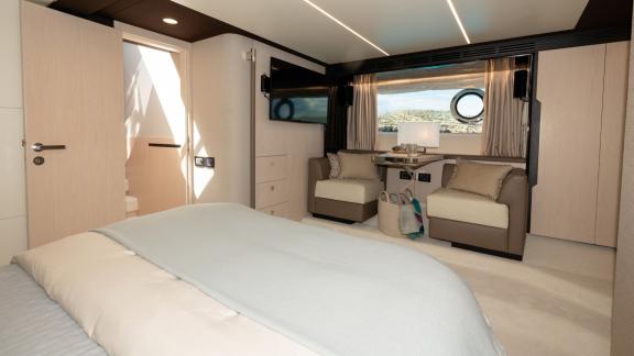 Sea Ya features a master cabin with a cozy seating area and sea views, offering premium yacht charter comfort.