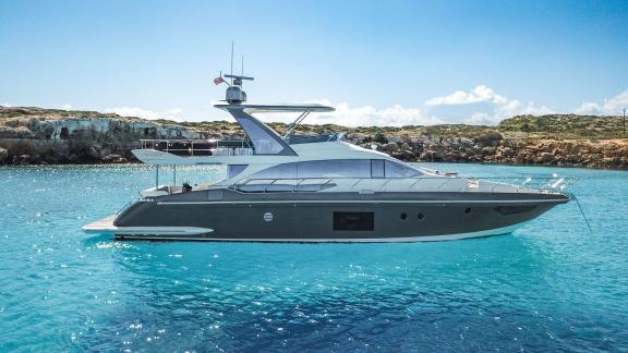 Sea Ya is anchored in a crystal clear bay near Athens, offering an elegant setting for private yacht charter.