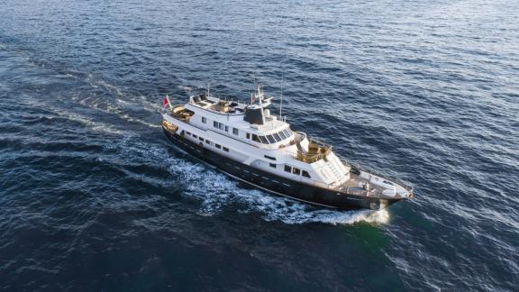 Among motor yacht rental options in Athens Sounion II is seen cruising with wide hull and upper deck in open sea.