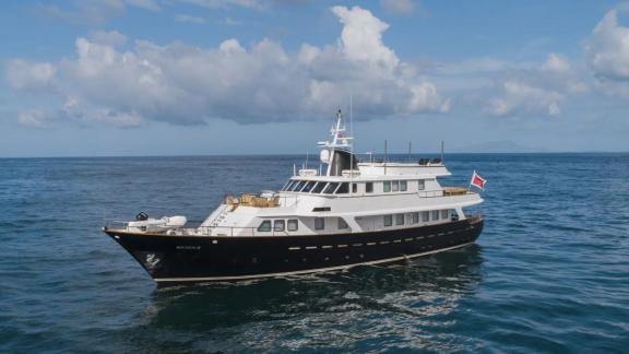 Among motor yacht rental options in Athens Sounion II is seen cruising with side profile and deck structure in open sea.