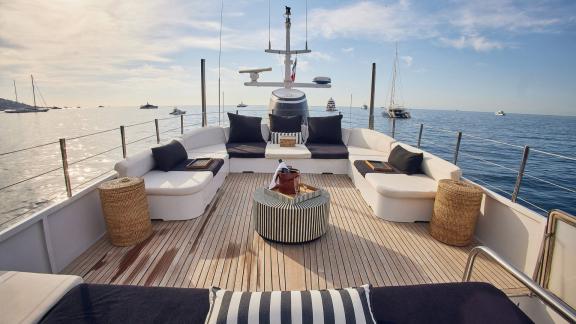 Among motor yacht rental options in Athens Sounion II upper deck large seating area is seen with sea view.