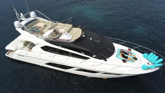 Among Nice yacht charter options Turquoise motor yacht shows flybridge seating and bow sunbathing area.