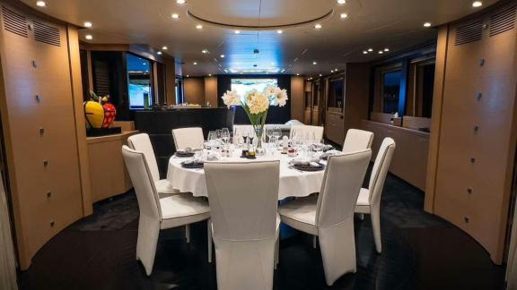 Among Mallorca yacht charter options Ycm120 shows elegant dining room with table.