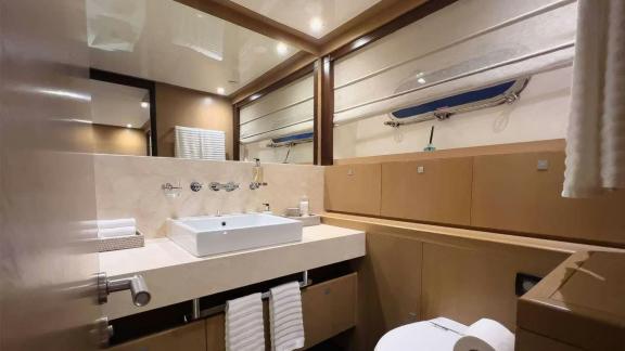 Among Mallorca yacht charter options Ycm120 shows stylish bathroom with sink and storage.