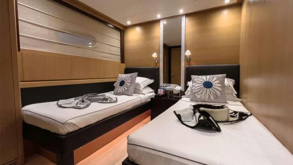 Among Mallorca yacht charter options Ycm120 shows cabin with separate beds and cozy stay.