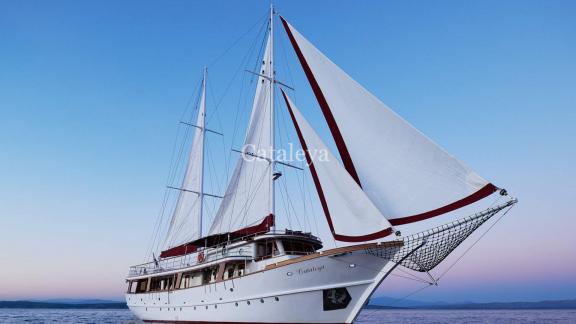 Gulet Cataleya with 9 cabins sails in the calm waters of Croatia at sunset.