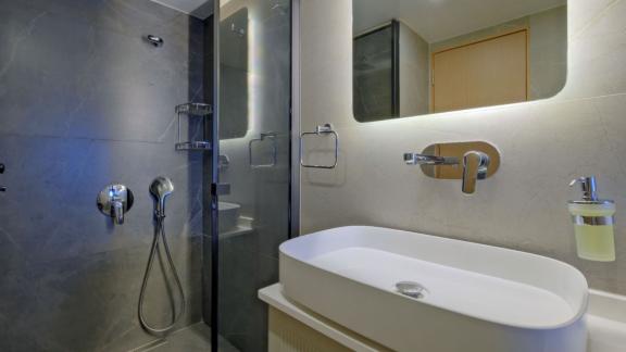 Among Fethiye luxury yacht options the 6 cabin 12 guest Dodo motorsailer features a modern bathroom with glass shower.