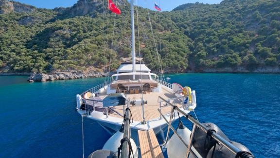 Anchored in Fethiye bay the 6 cabin 12 guest Dodo motorsailer shown from bow with spacious foredeck area.