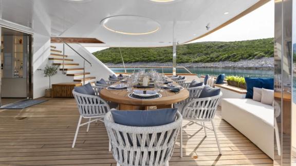 In Split motorsailer charter option Maxita aft deck with dining table and seating area visible.
