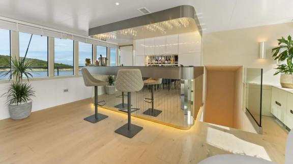 In Split motorsailer charter option Maxita interior bar area with stools and seating visible.