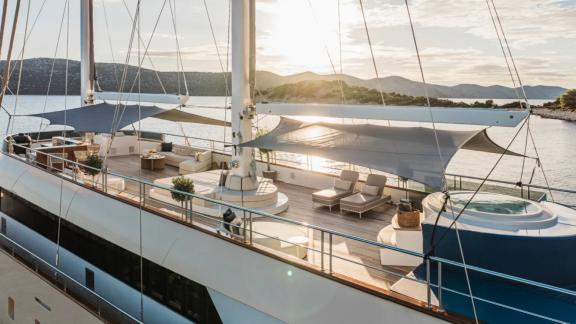 In Split motorsailer charter option Maxita upper deck with lounge area and jacuzzi visible.