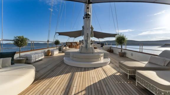 In Split motorsailer charter option Maxita upper deck with wide seating and relaxation area visible.