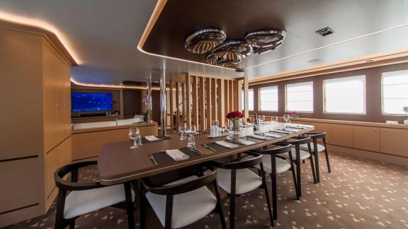 Stylish dining area inside Omnia with modern design and set table.