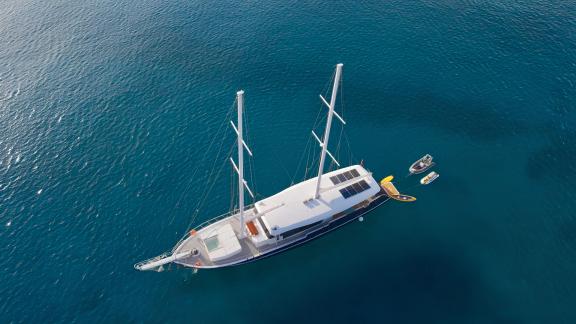 Luxurious S4 motor yacht from above, with two masts in the turquoise waters of Bodrum