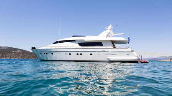 The stylish motor yacht anchored in the crystal-clear waters of Athens, ready for exclusive charters.