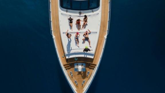 Archsea motoryatın ön kısmında misafirler güneşleniyor. Bodrum koylarında lüks ve konfor bir arada.