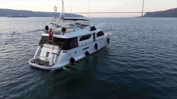 Göcek yacht rental with Ayem offers a scenic cruise near the iconic Turkish bridge.