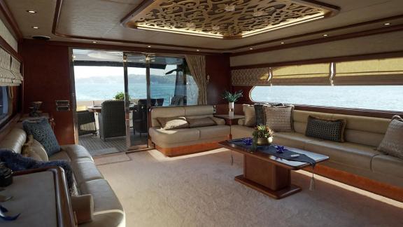 Göcek motor yacht Ayem features a bright, panoramic salon with views over the water.