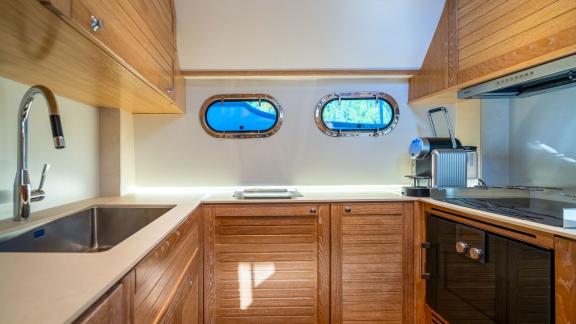 The galley of Cloud 9 is designed with spacious counters and a stylish layout, perfect for convenient onboard cooking.