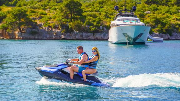 A couple enjoys jet skiing near the Cynthia motor yacht anchored off the coast of Makarska.