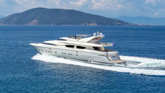 The luxury yacht Divine speeds across the open sea, showcasing its power.