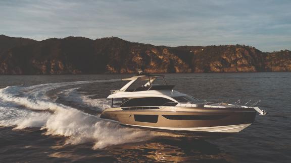 Elegant motor yacht cruising at sunset along the Croatian coast.