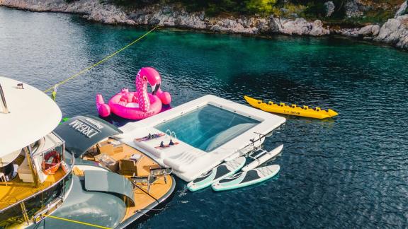 Die Motoryacht Dream liegt mit Wasserspielzeug im Grünen. Paddleboards und Pool inklusive.