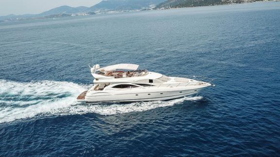 The Edition yacht swiftly cruises through the blue waters of the Aegean Sea, offering comfort and luxury.