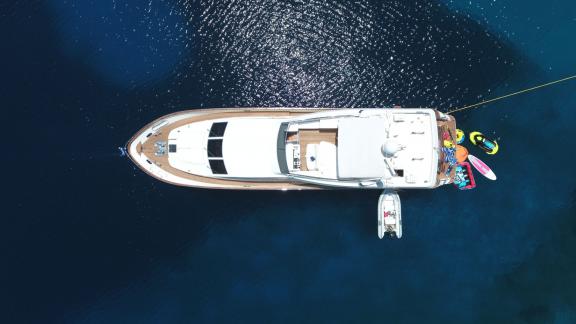 An impressive aerial view of the Efmaria motor yacht in calm waters.