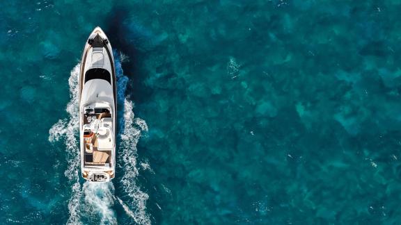Ehthele motor yacht speeds through turquoise waters off Mallorca.