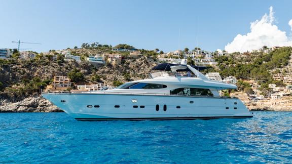 Ehthele motor yacht cruising smoothly along the scenic coast of Mallorca.