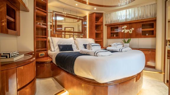 The guest cabin of the yacht Estia Zeus provides comfortable accommodation with a cozy bed and stylish decor.